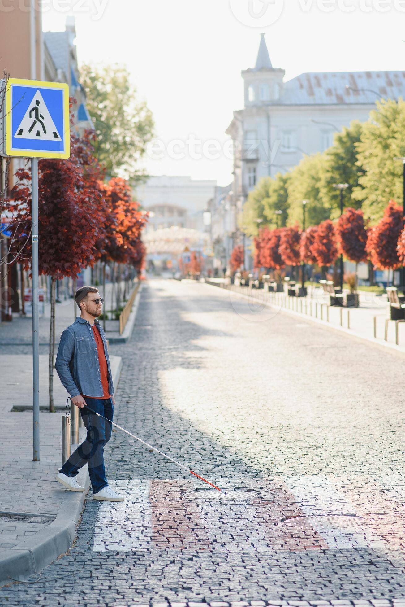 Blind young man crossing road 45671840 Stock Photo at Vecteezy