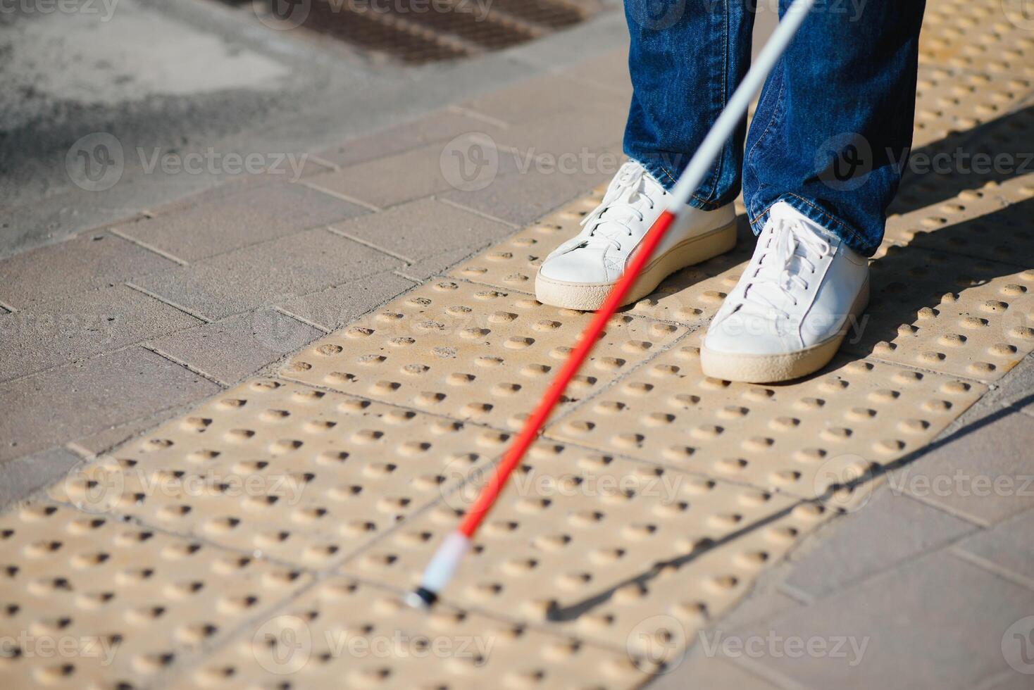 Close-up Of A Blind Man Standing With White Stick On Street photo