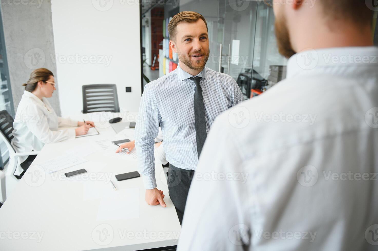 Corporate business team and manager in a meeting room at modern office with panoramic windows. Business concept photo