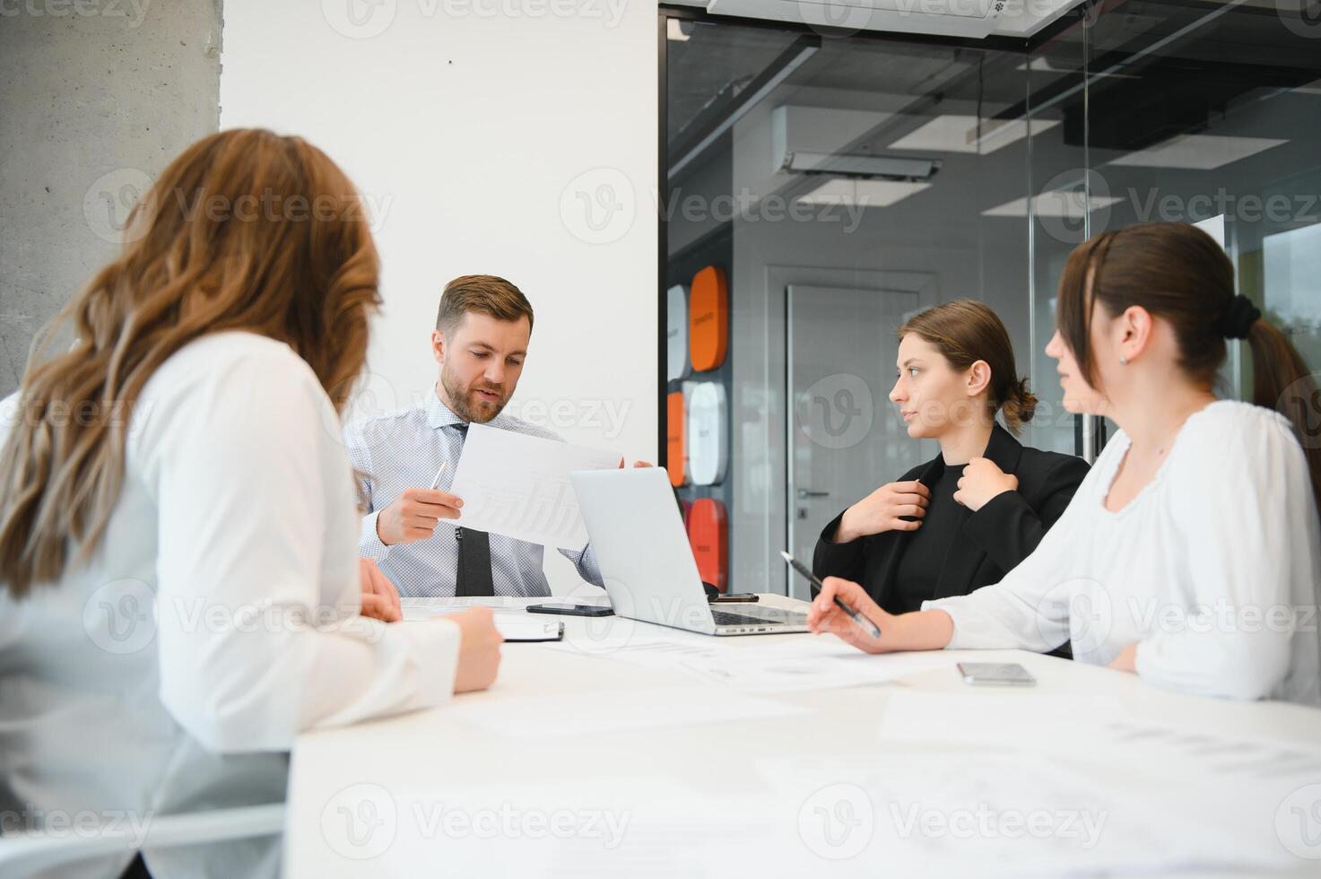 Corporate business team and manager in a meeting room at modern office with panoramic windows. Business concept photo