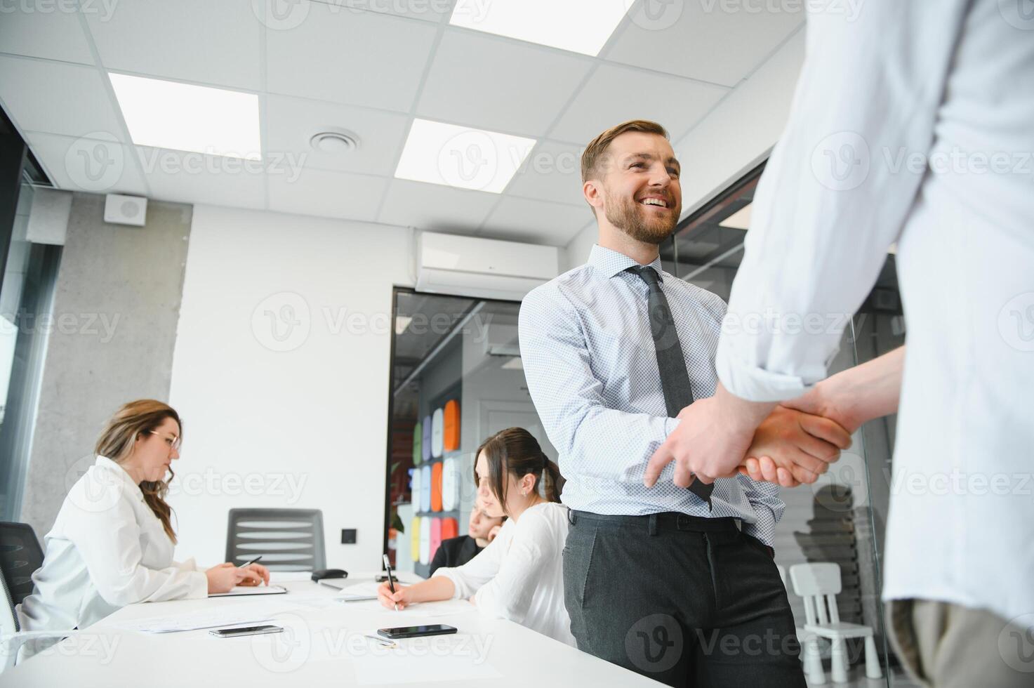 Corporate business team and manager in a meeting room at modern office with panoramic windows. Business concept photo