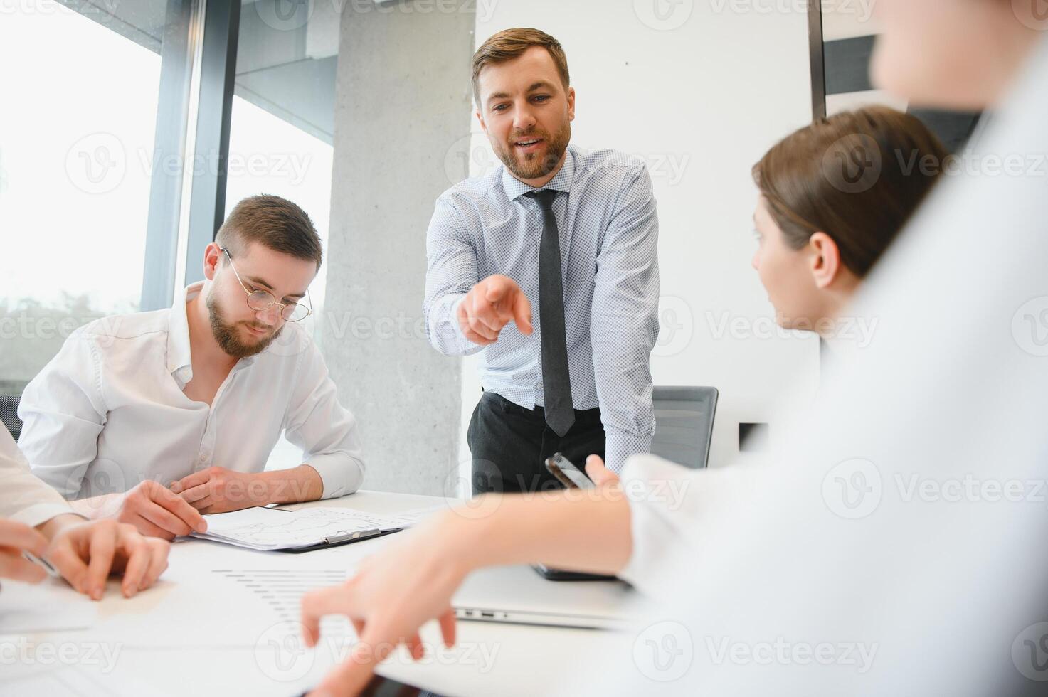 Corporate business team and manager in a meeting room at modern office with panoramic windows. Business concept photo