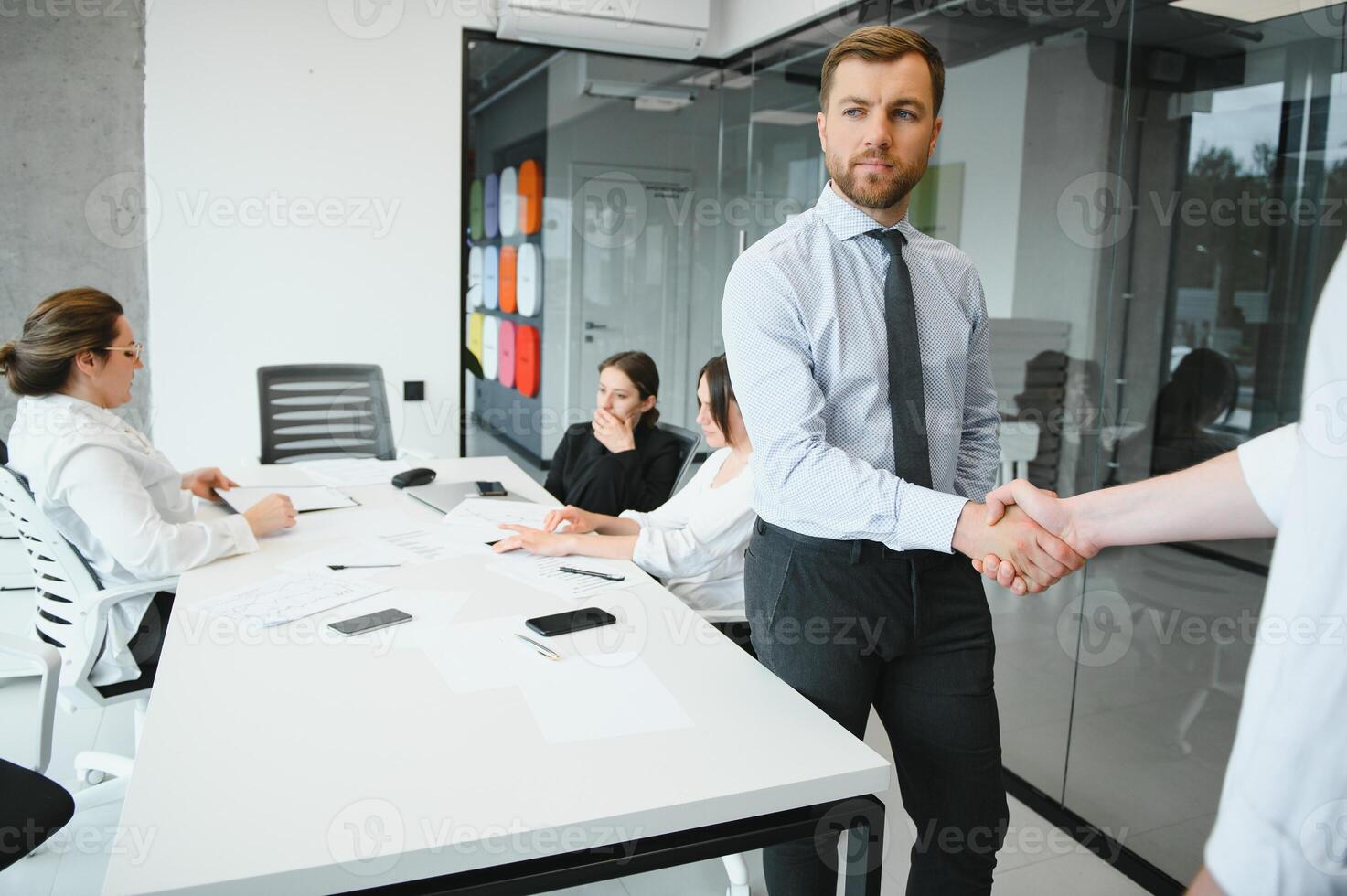 Confident and successful team. Group of people are working together in office. Blurred background photo