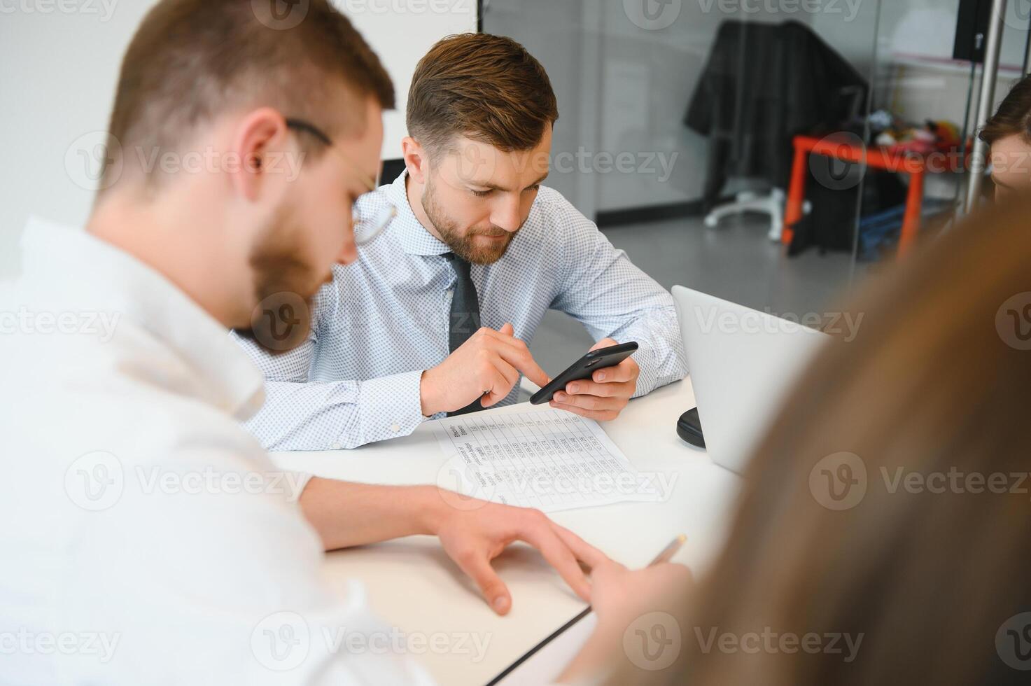 Confident and successful team. Group of people are working together in office. Blurred background photo
