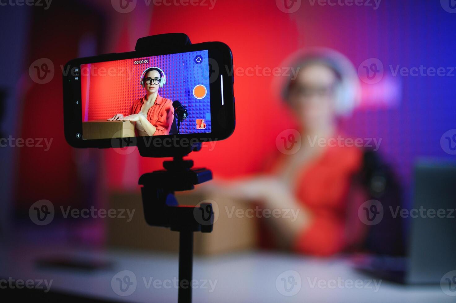 A young blogger girl records a and unpacks a box with goods from an online store photo