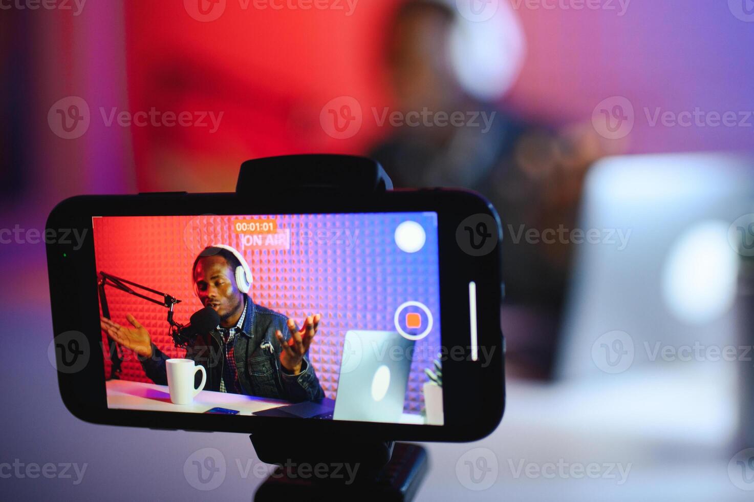 Handsome Young African American Man Talking Into Microphone While Recording Radio Show photo