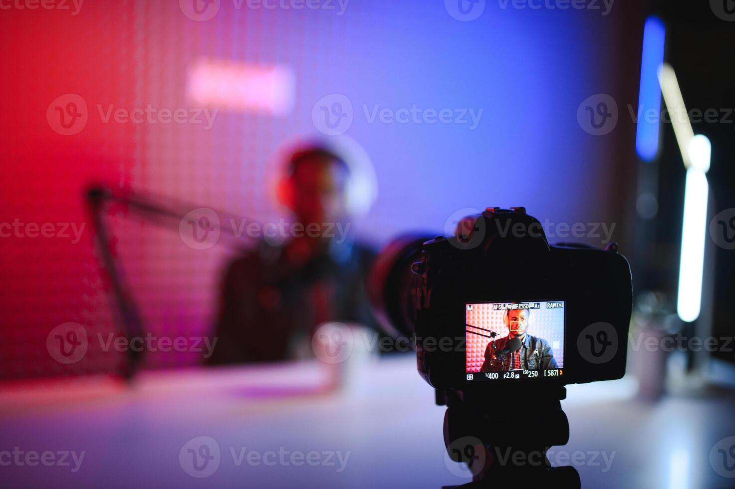 Handsome Young African American Man Talking Into Microphone While Recording Radio Show photo