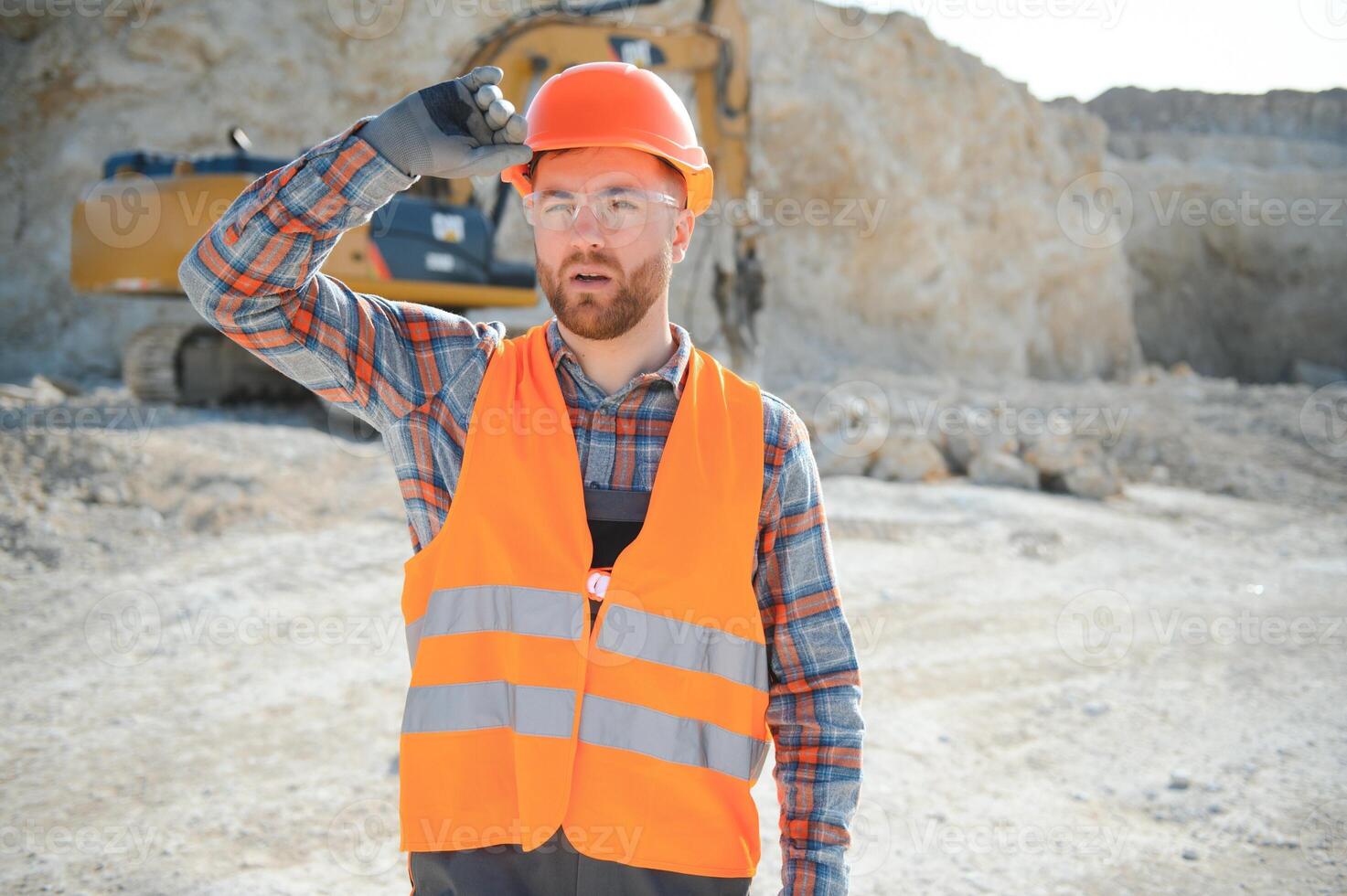 Extraction of stone. Male worker next to stone quarry. Engineer at construction site photo