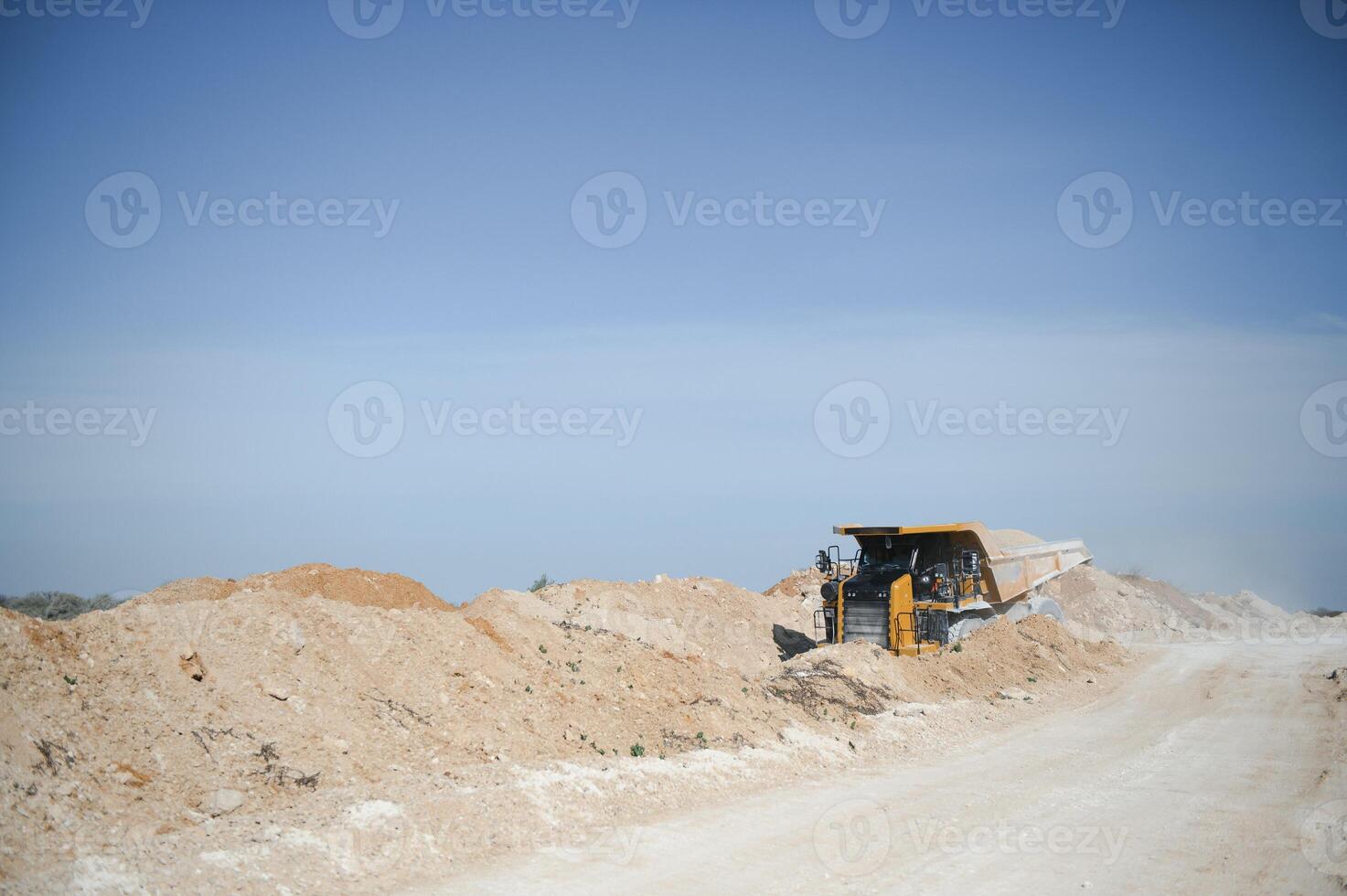 Large quarry dump truck. Big yellow mining truck at work site. quarry photo