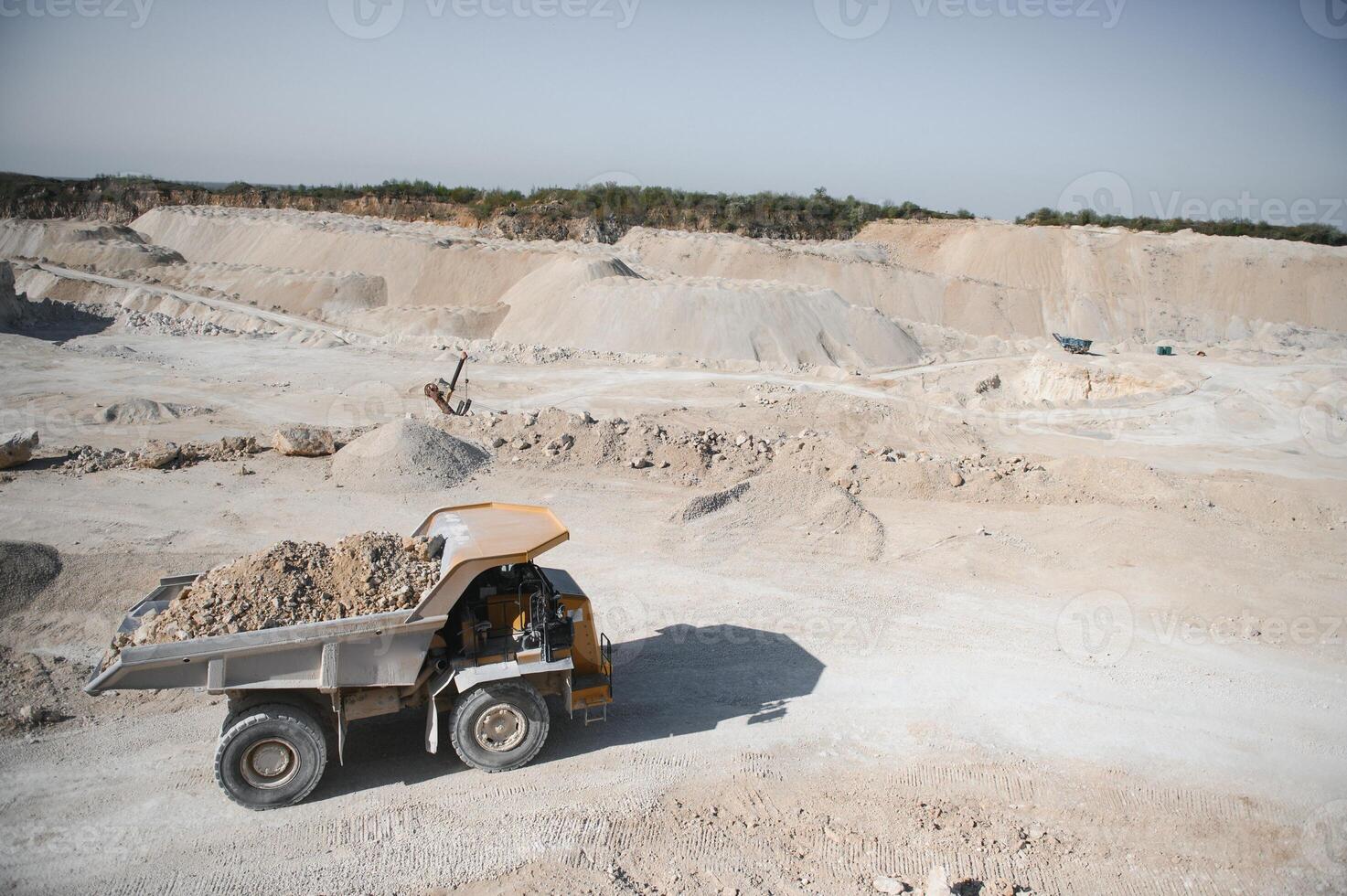 Large quarry dump truck. Big yellow mining truck at work site. quarry photo