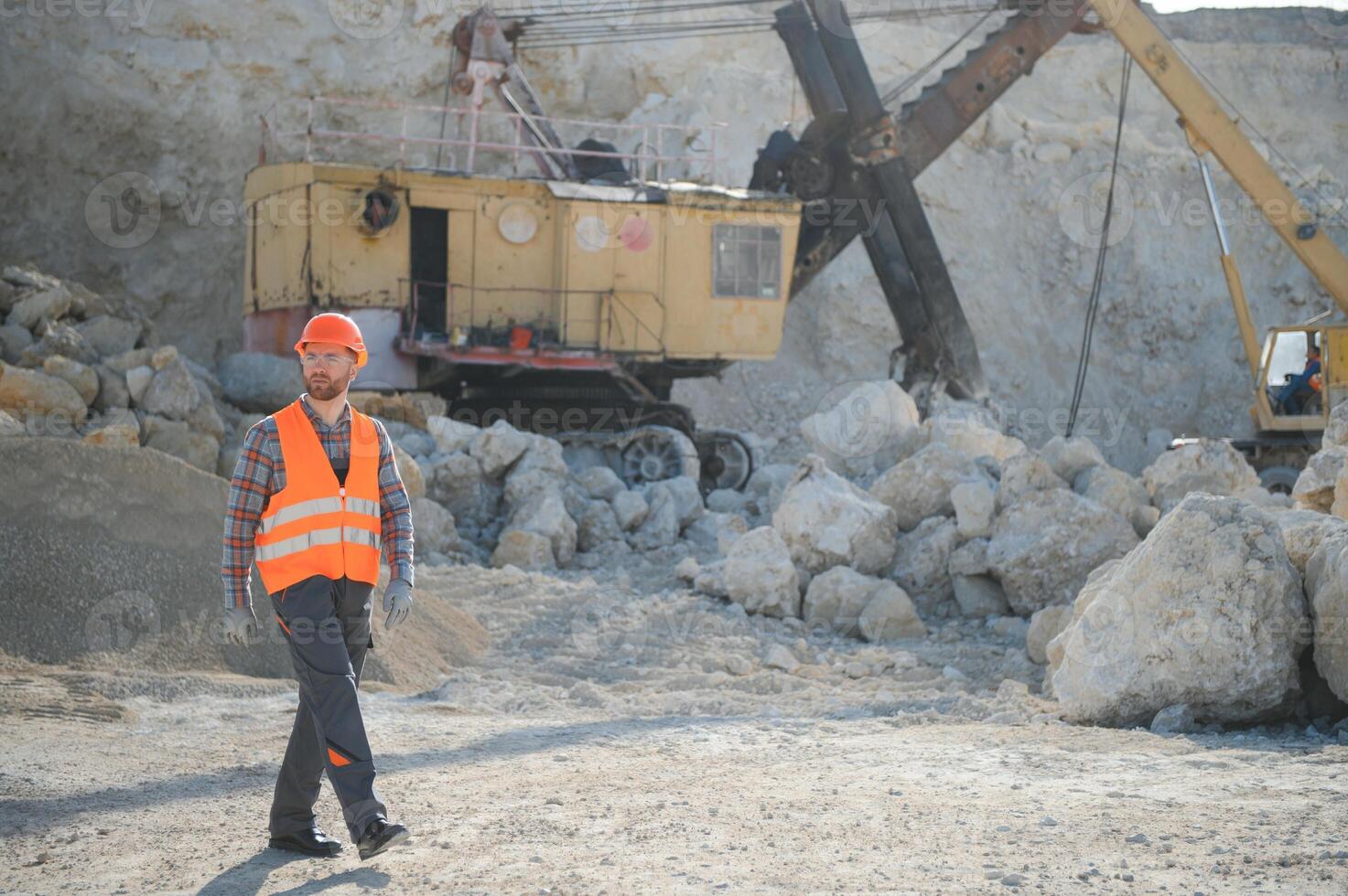 Worker and quarry in background photo