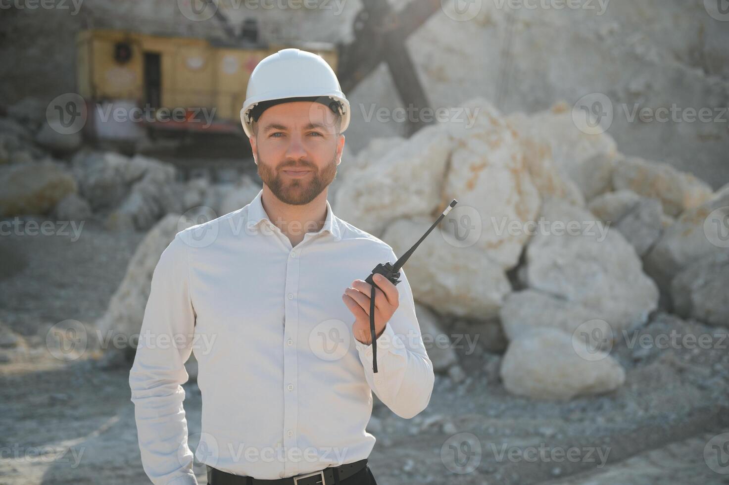 Male worker with bulldozer in sand quarry photo