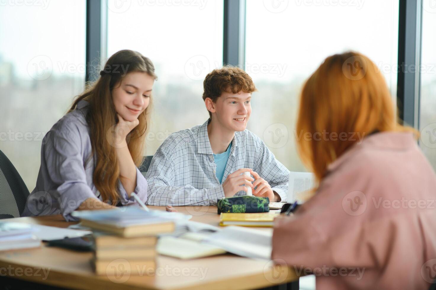 Group of college students doing homework photo
