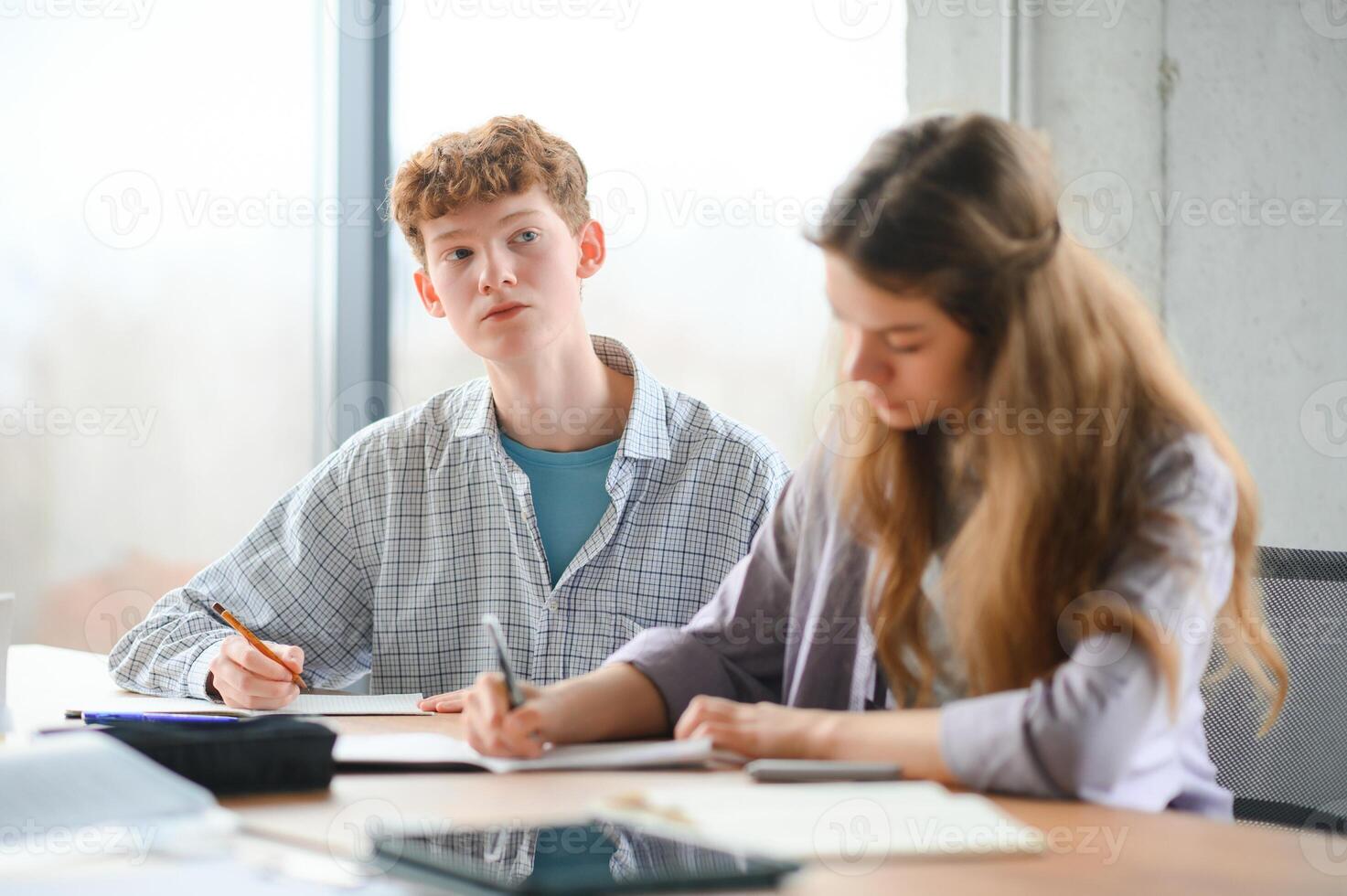 Group of college students doing homework photo