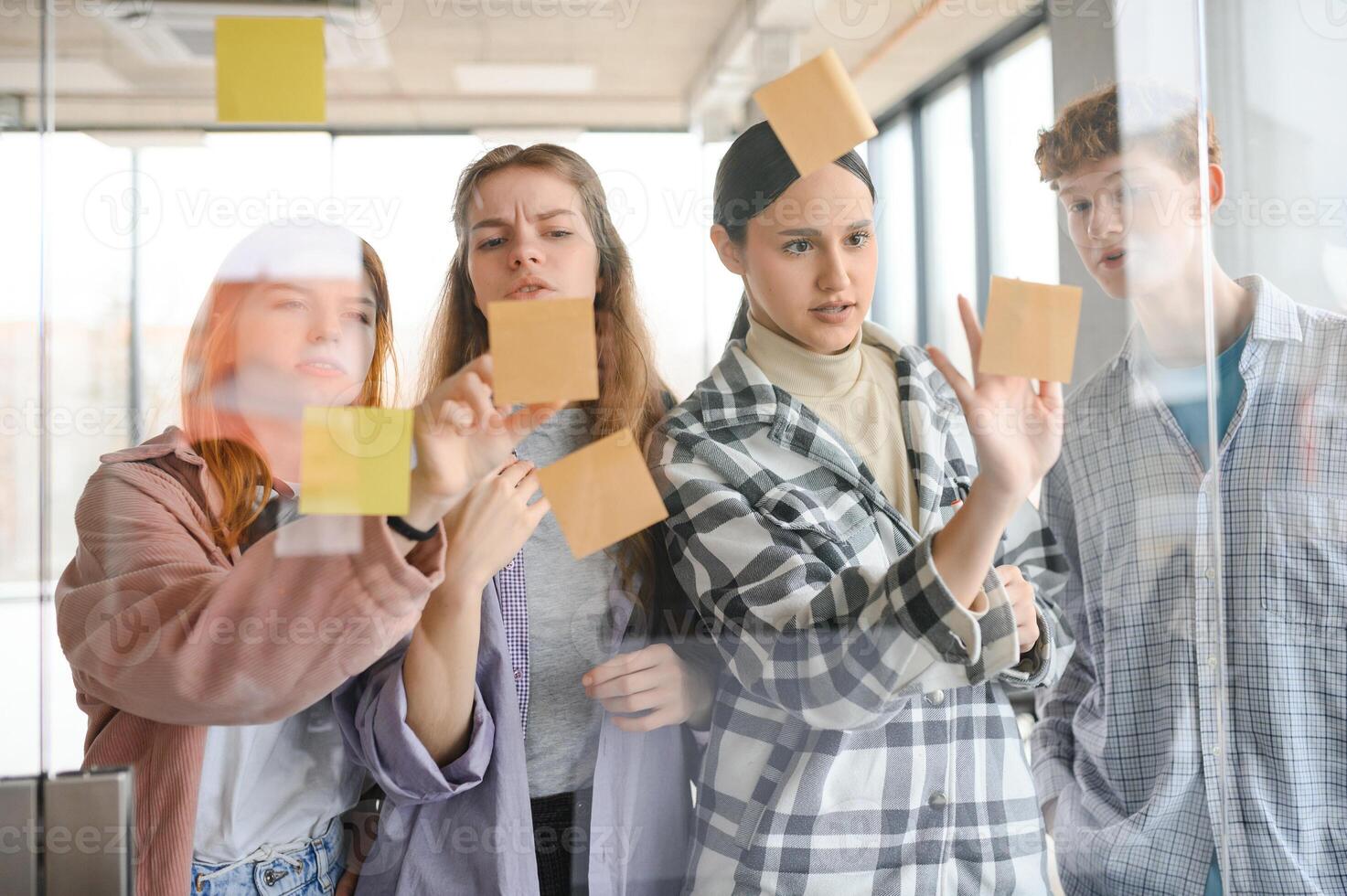 students discuss university assignments together photo