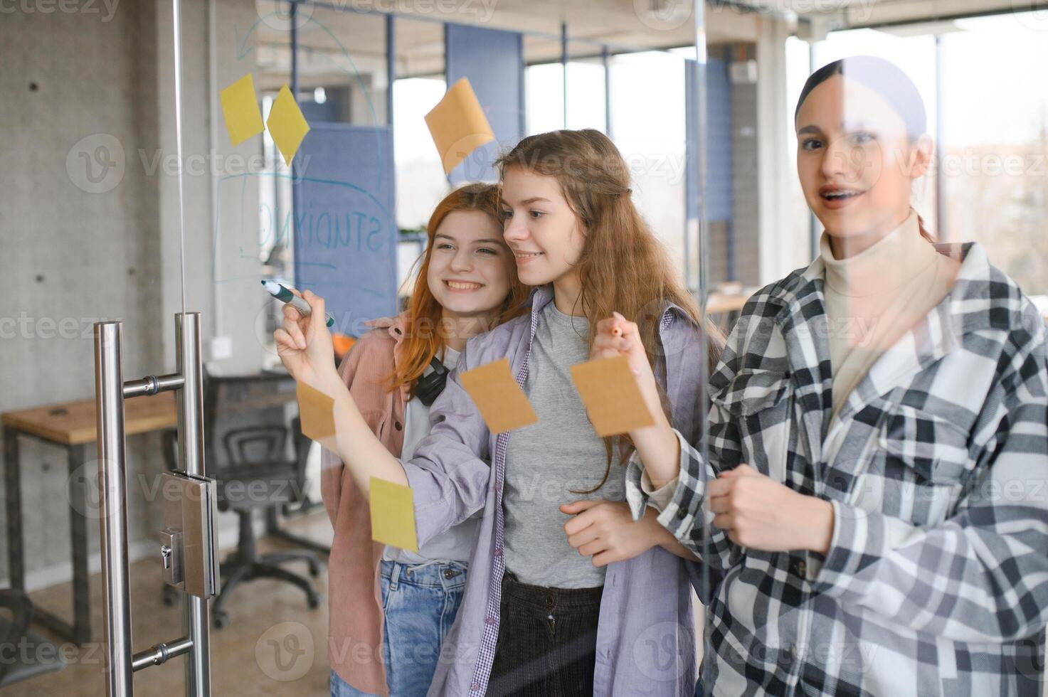 students discuss university assignments together photo