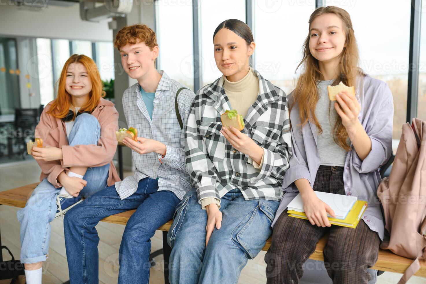 Happy high school students in the classroom photo