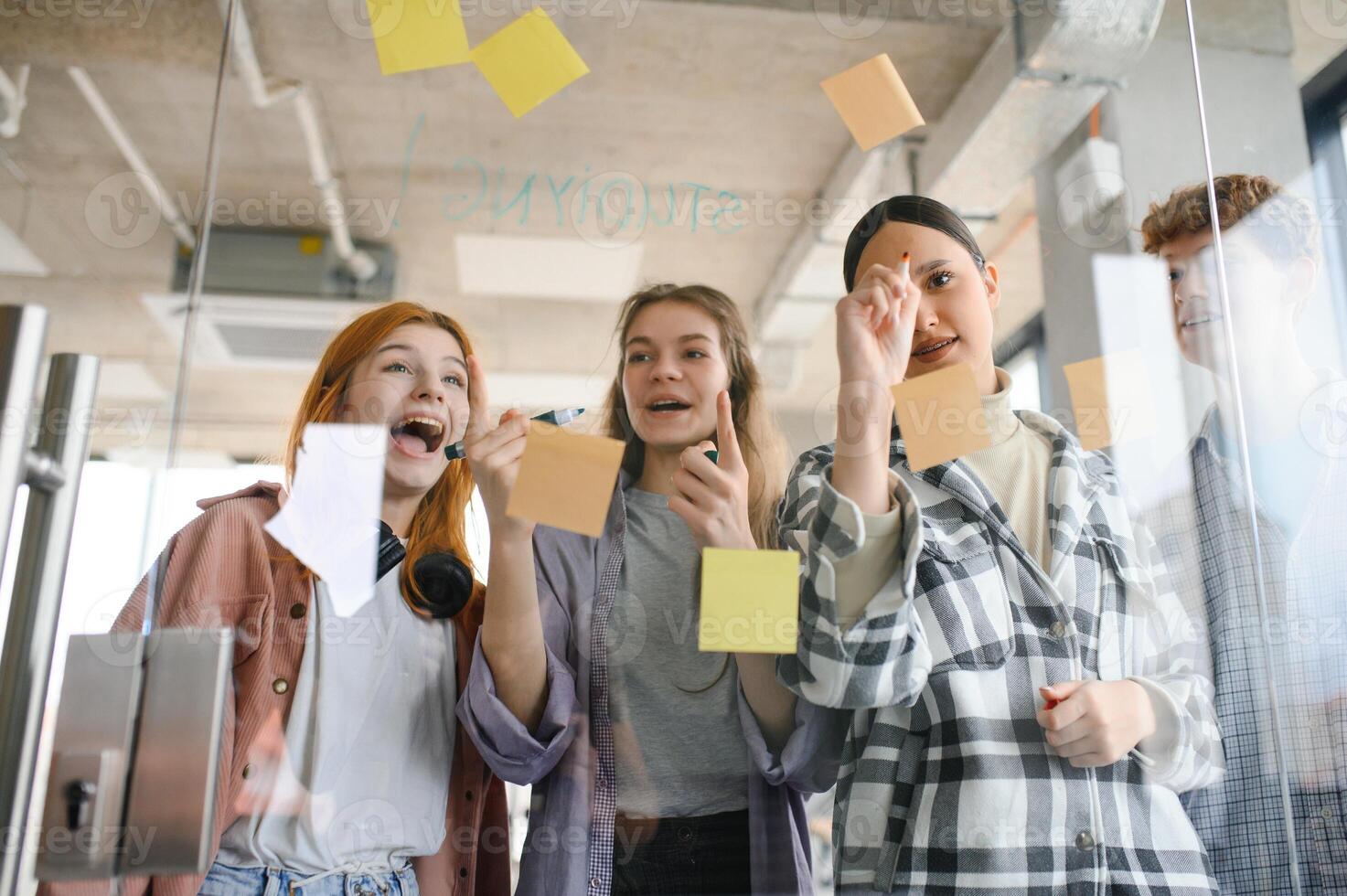 students discuss university assignments together photo