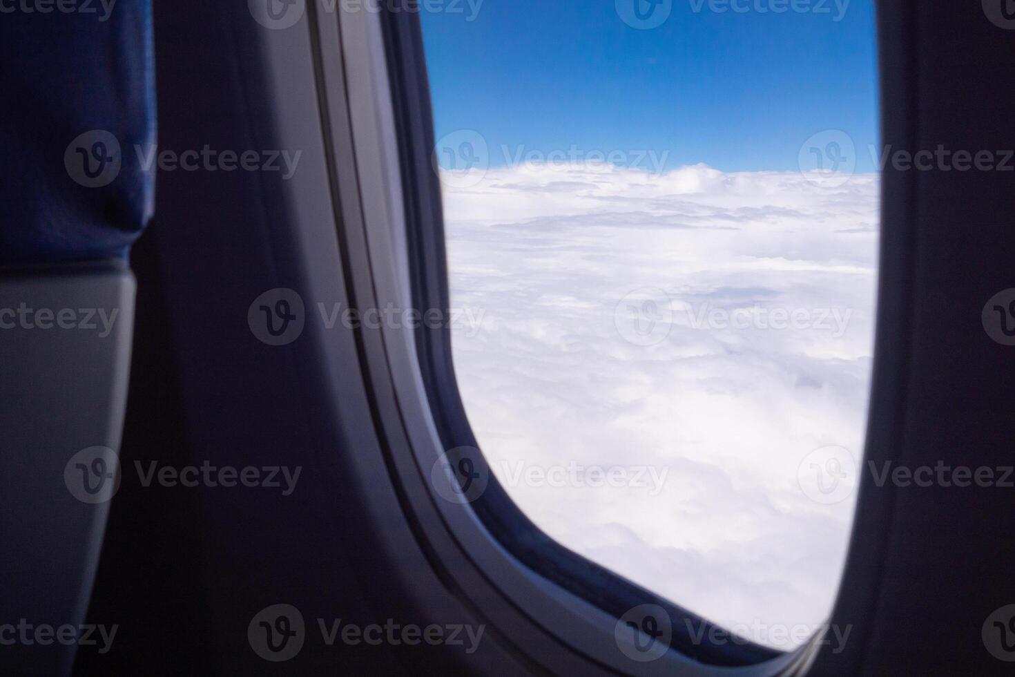 Aerial view of cloudscape seen through airplane window photo