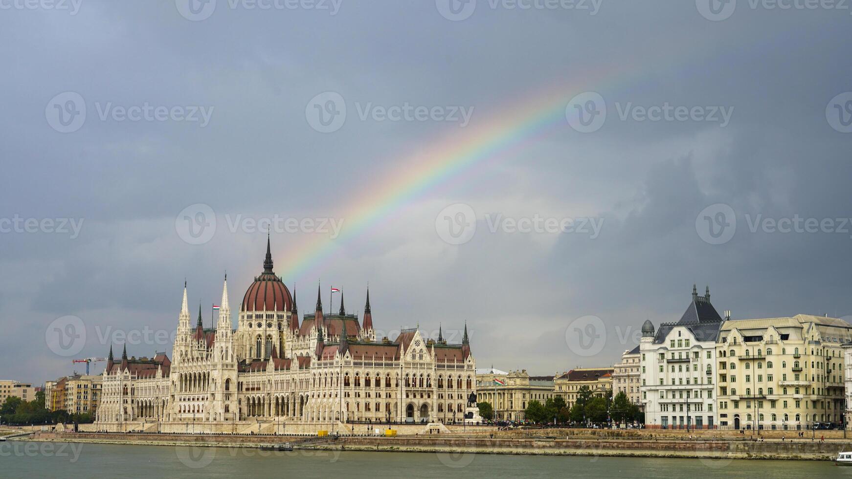 Rainbow over Budapest - The Iconic Hungarian Parliament Building Adorned with a Spectrum of Light photo