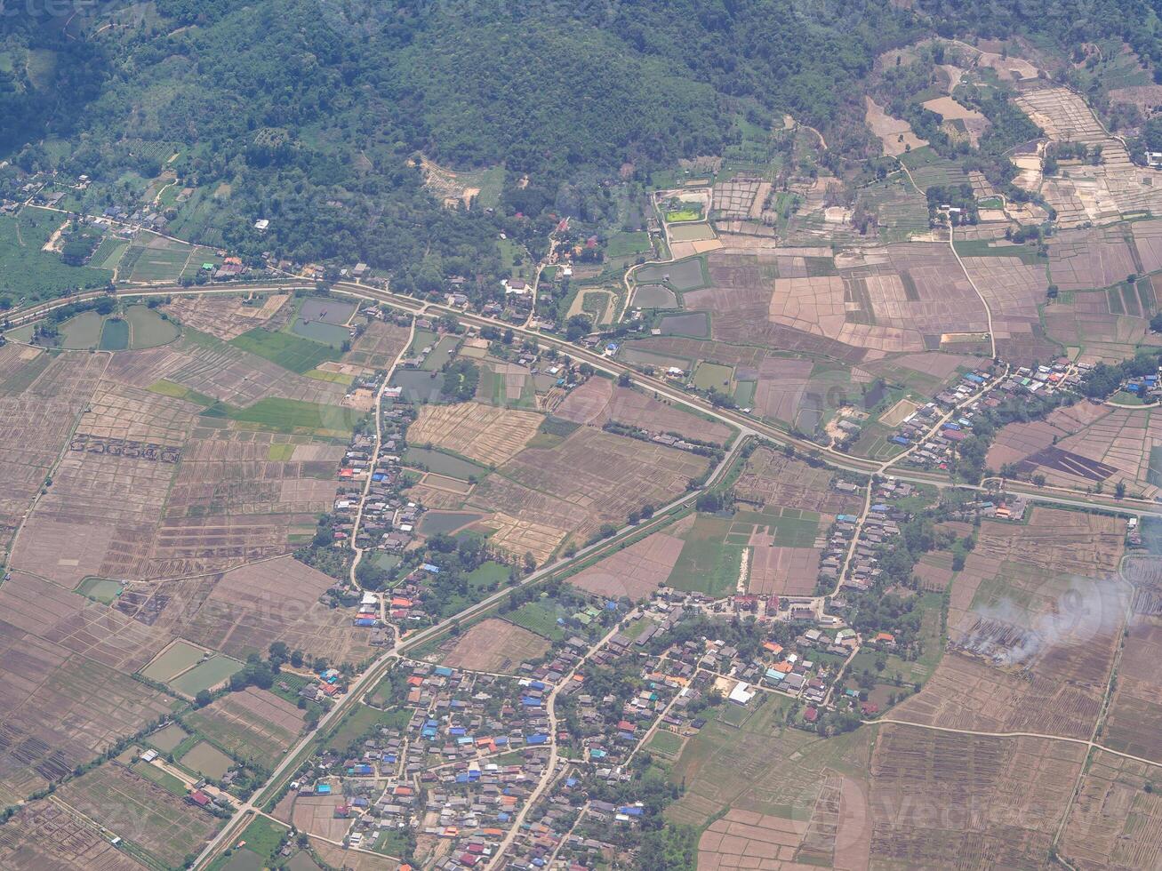 Aerial view of agricultural field through the airplane window photo