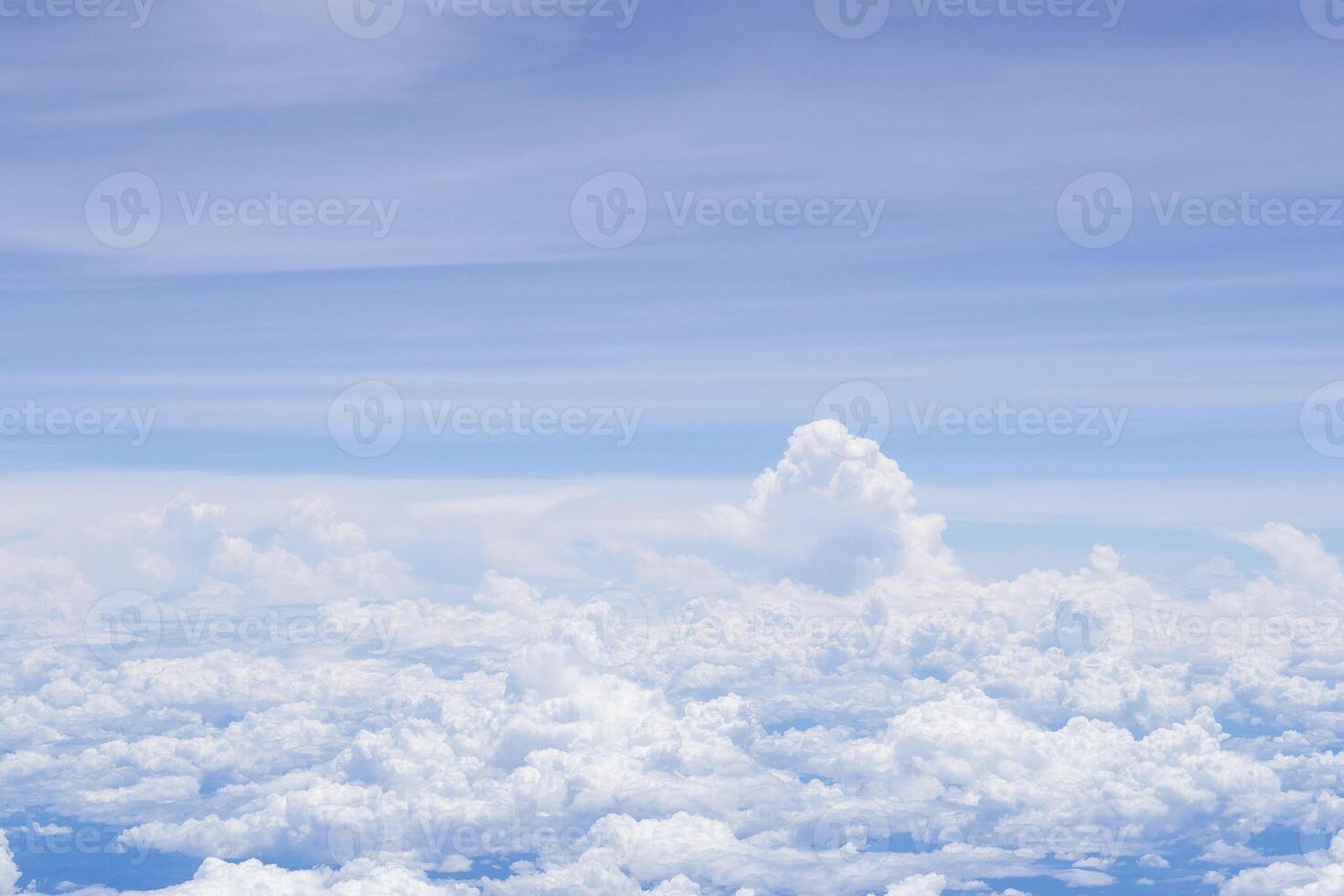 Aerial view of clouds and sky seen through the airplane window photo