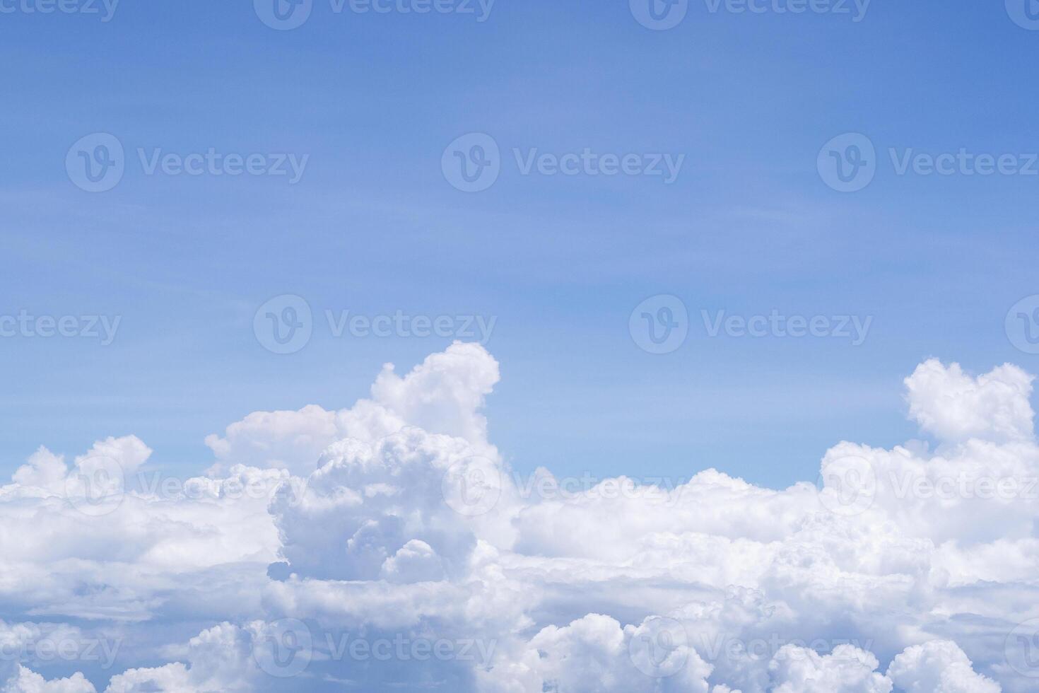 Aerial view of clouds and sky seen through the airplane window photo