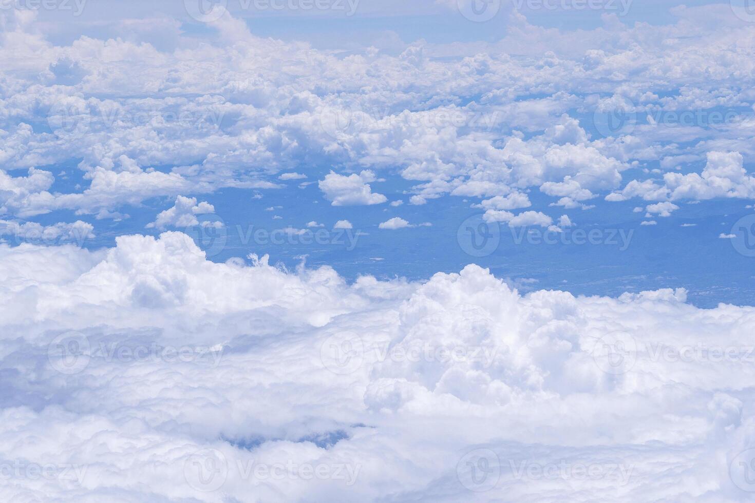 Aerial view of sky and clouds are seen through the airplane Window photo