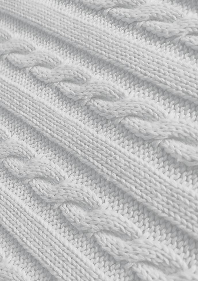 White background vertical texture of knitted pattern with pigtail photo