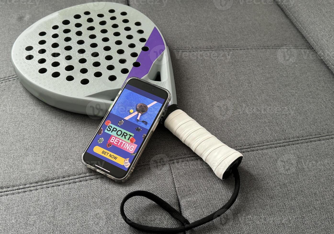 padel tennis and sports betting on a smartphone. Concept of sports bet photo