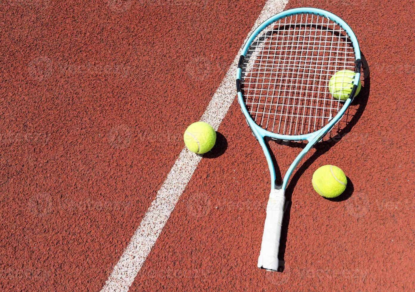Tennis scene with balls, racquets and hard court surface corner lines photo