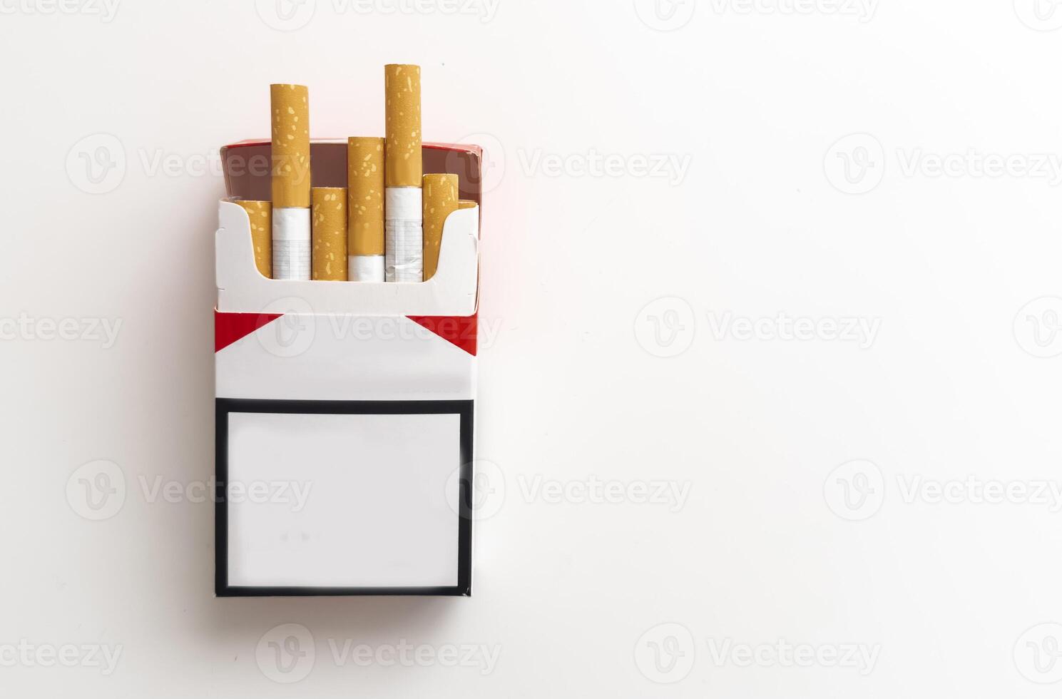 Open pack of cigarettes and a cigarette on a white background. photo
