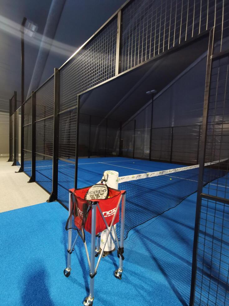 Ukraine Kyiv, April 11 2024. Padel racket adidas and padel ball on a green court photo