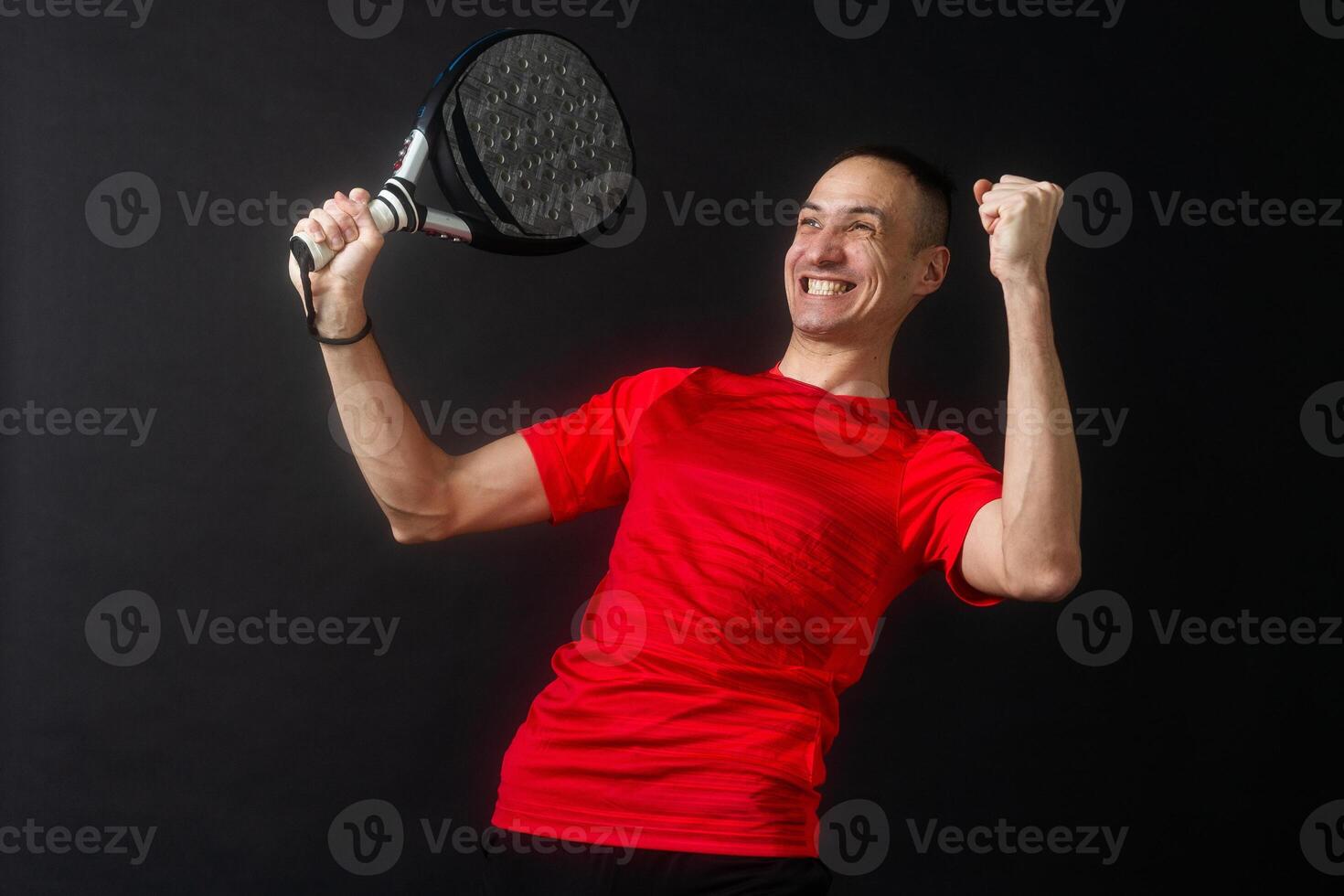 Professional monitor of paddel holding a black racket. Man paddel player playing a match. photo