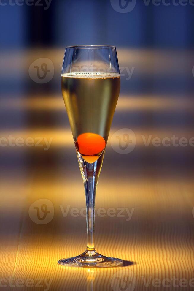 Champagne cocktail, light drink with a cube of sugar, cognac, angostura and brut champagne photo