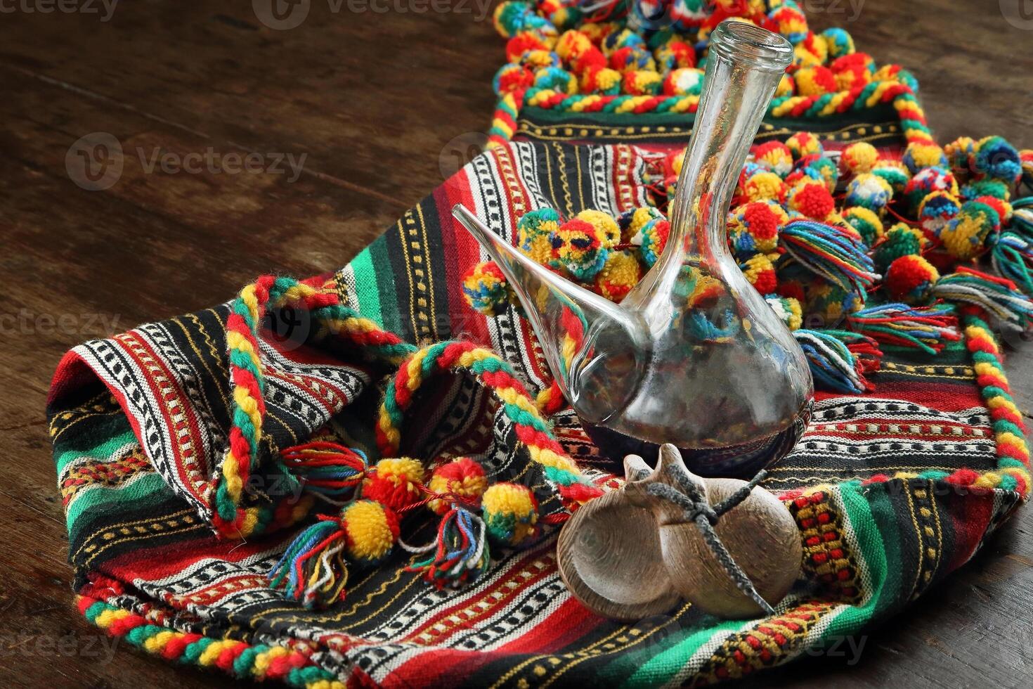 Blanket with porrones with wine and castanets on wooden table photo