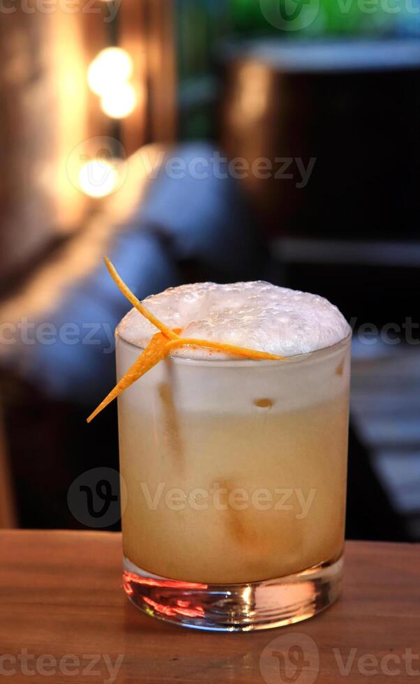 Smoky Whiskey Sour, delicious drink with scotch whiskey, lemon, maple syrup and angustura photo