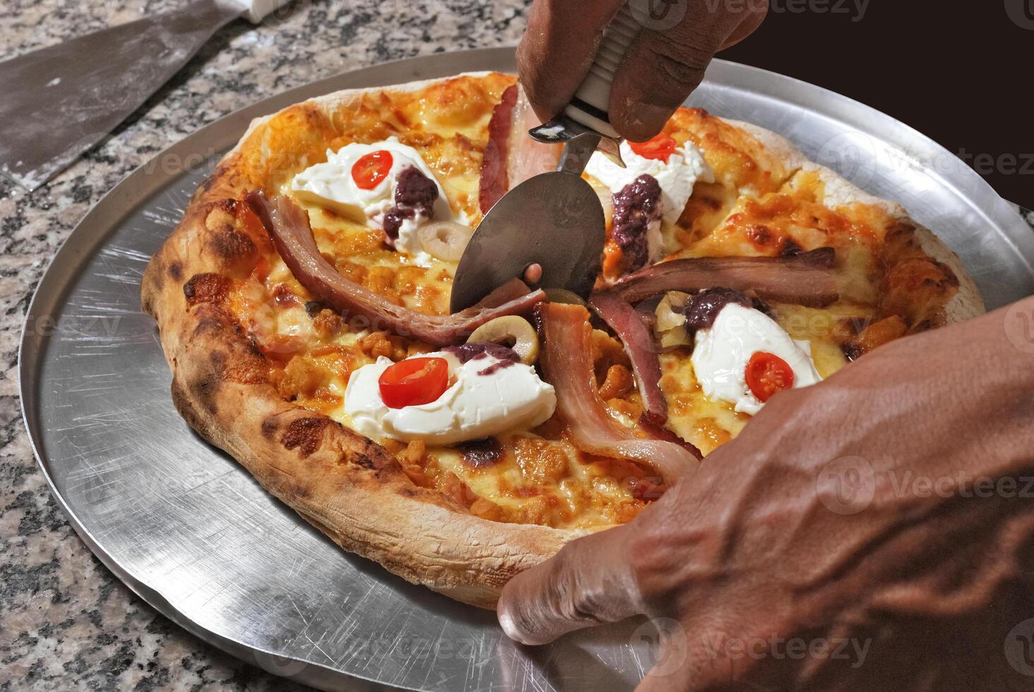 bacon pizza with cream cheese, cherry tomatoes and olives photo