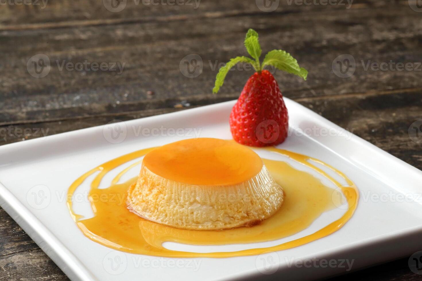 Milk pudding with strawberry and caramel sauce photo