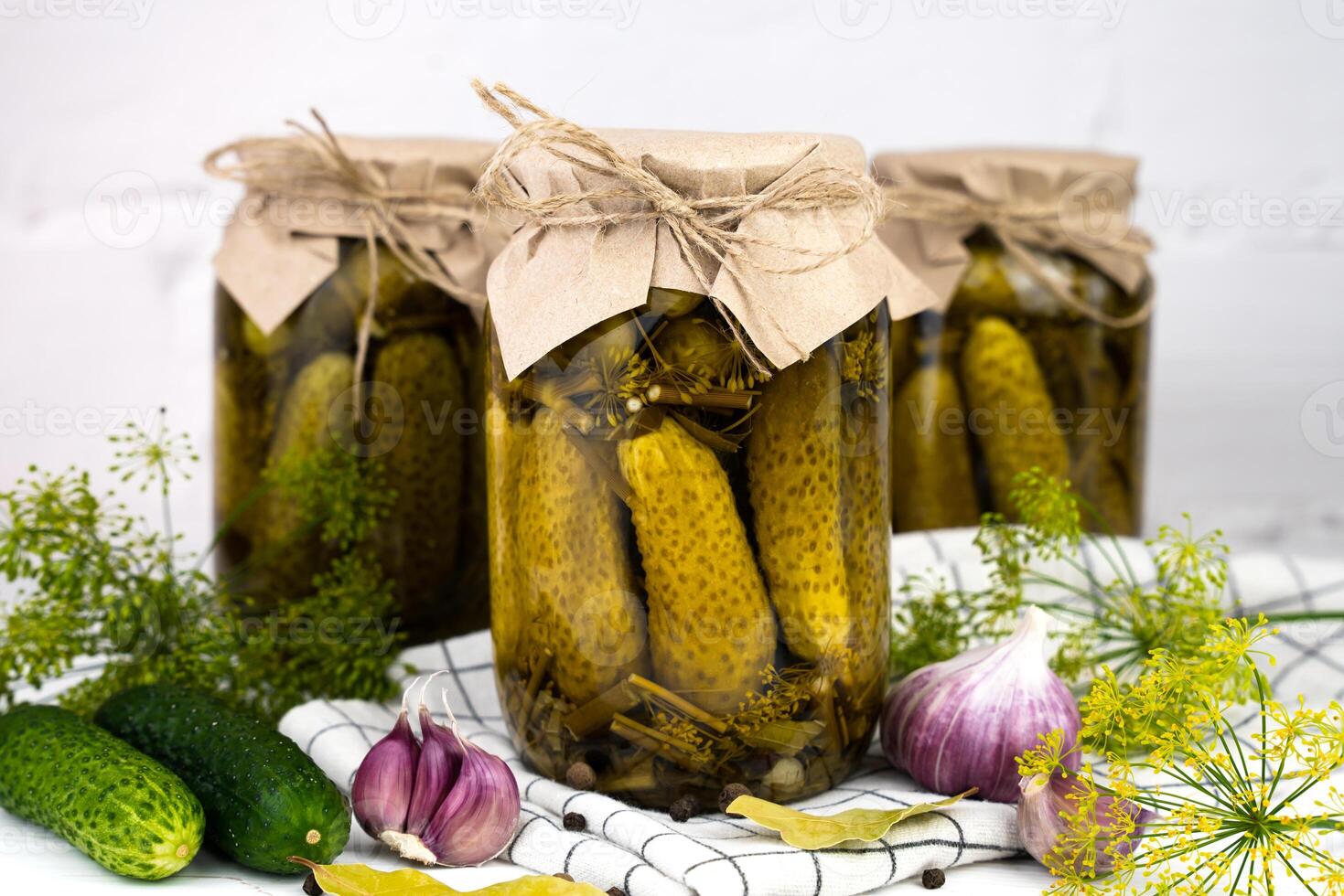 Canned cucumbers on a kitchen table. Delicious homemade pickles. Close-up. photo