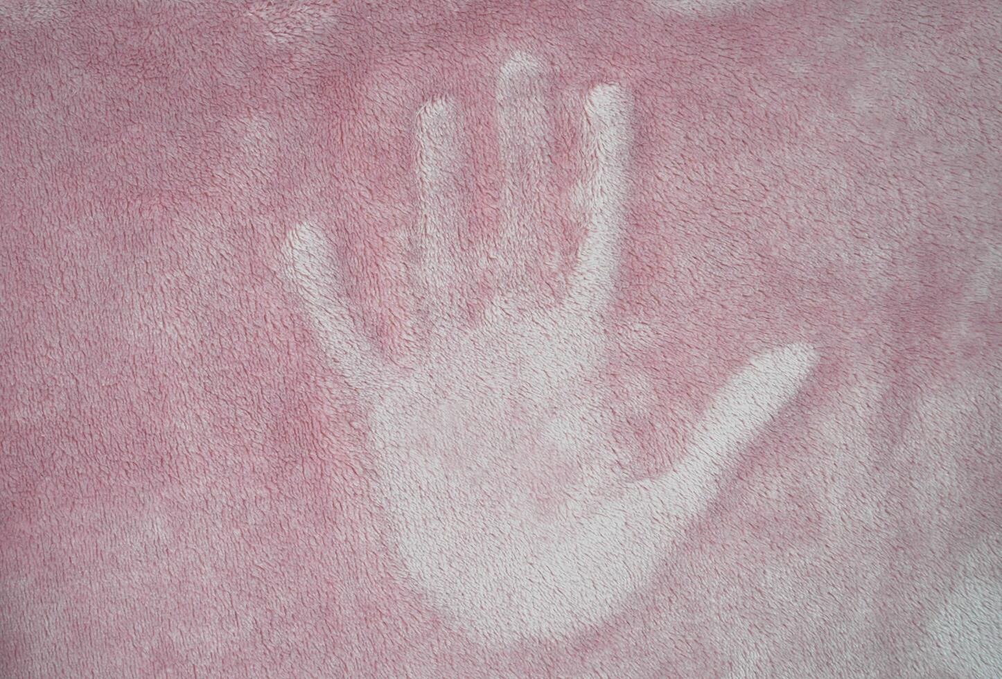 The footprint of a people hand on the surface of the fabric. Copy space. Selective focus. photo