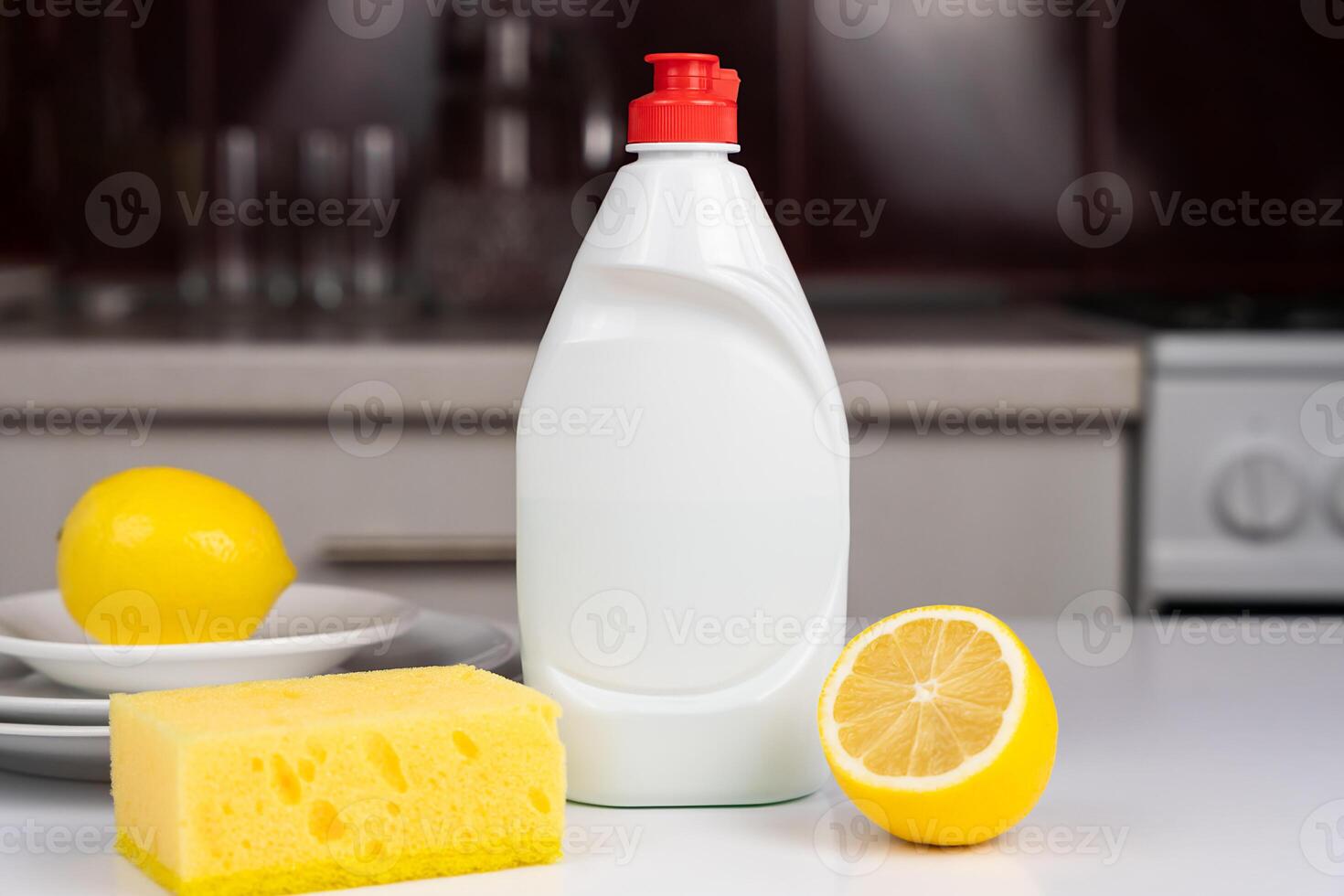 Detergent, lemon and kitchen sponge on the kitchen table. Freshness and purity. Close-up. Selective focus. photo