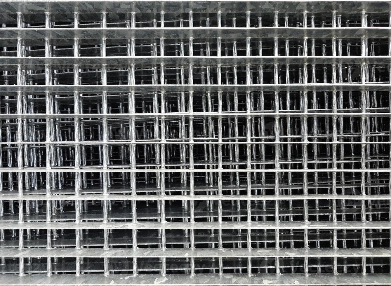 Durable metal grille. Fencing or decking material. Gray industrial back photo