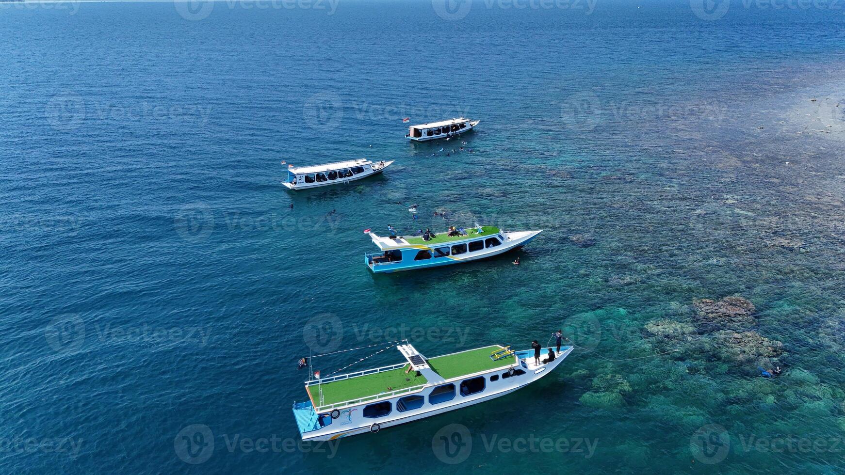 Top view or aerial view of Beautiful crystal clear water and white beach with long tail boats in summer of tropical island photo