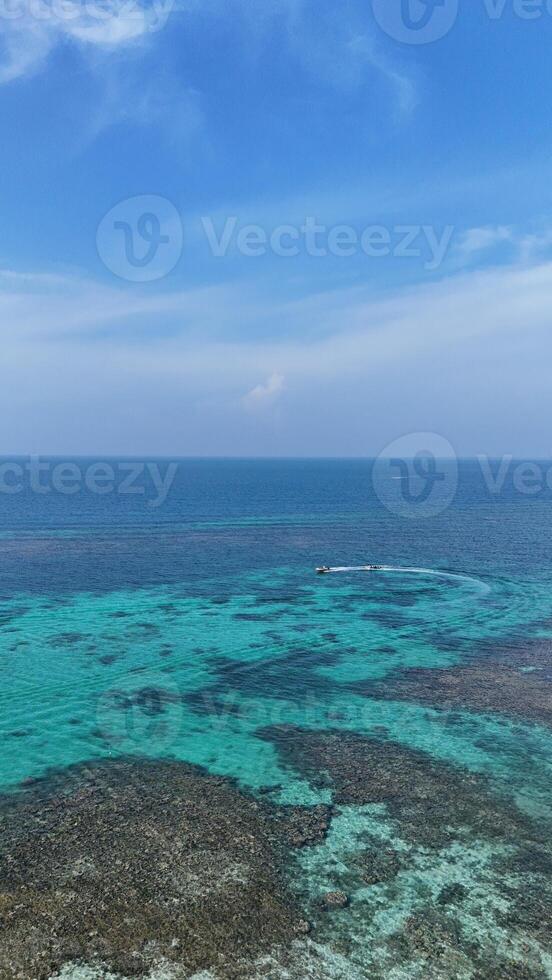 Panoramic view of blue calm sea and blue clear sky in the summer afternoon at the coast of a tropical island photo