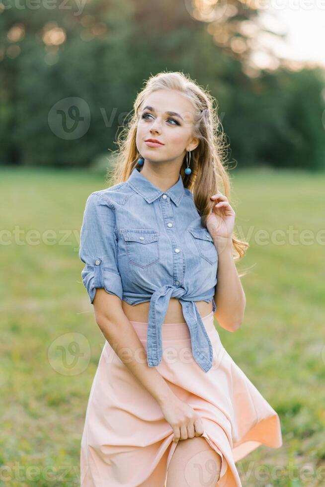 Happy Caucasian young woman, girl walking in the summer outdoors in nature photo