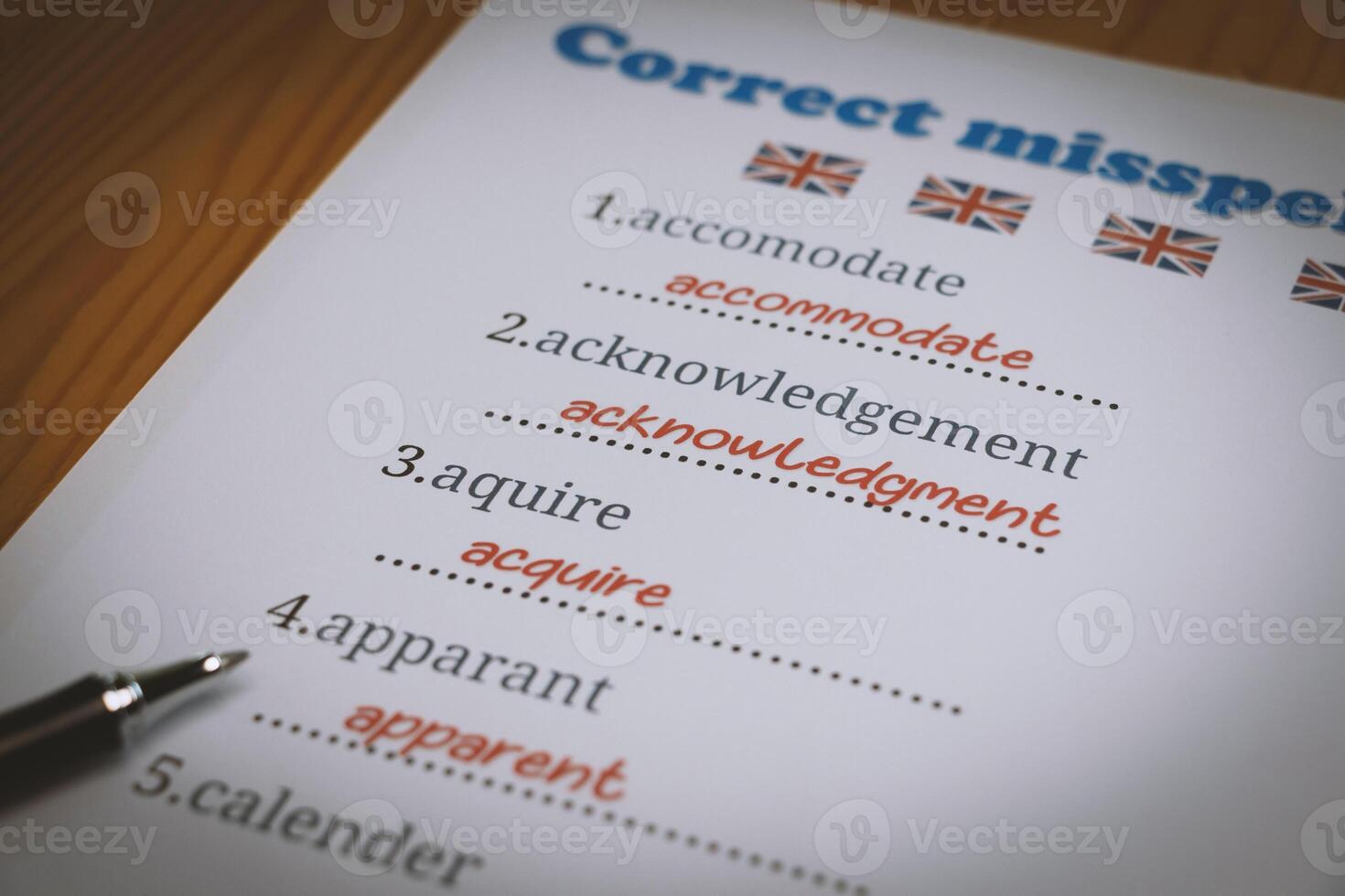 English misspelling worksheet with pen and tablet photo