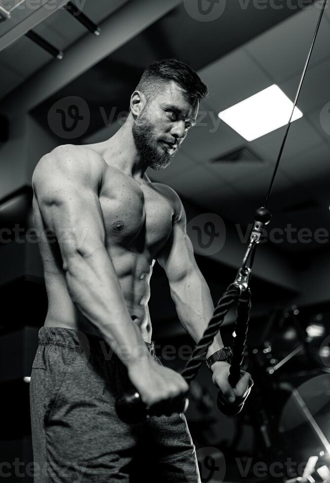 Athletic handsome macho with strong arms. Angry man training shirtless. photo