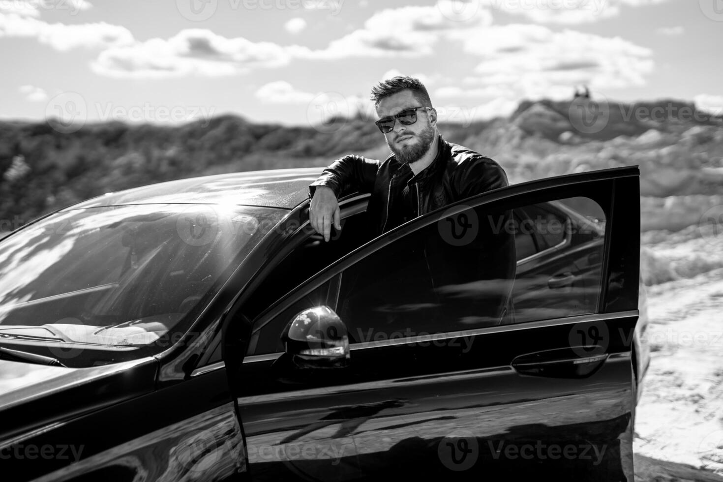 Young transport driver outdoor looking. Handsome man with car standing. photo