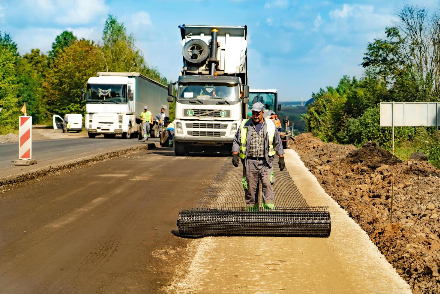 Road building process. Machinery modern highway repairing. photo